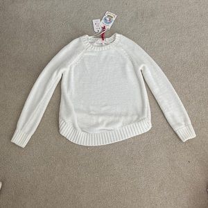 a kids white sweater. never worn. still has tags. has a sorta cross back